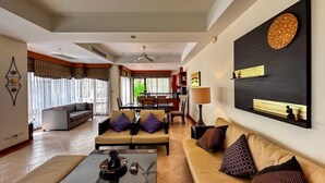 A spacious living room with a sofa set, a coffee table, and a dining area in the background. - Beautiful 3-bed Villa in Cherngtalay, Thalang (Choeng Thale)