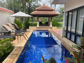 A swimming pool with a tiled deck, lounge chairs, and a gazebo. - Beautiful 3-bed Villa in Cherngtalay, Thalang (Choeng Thale)