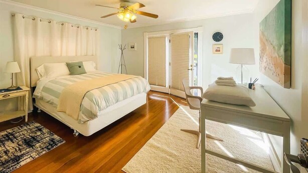A bedroom with a bed, a desk, a chair, a ceiling fan, and a window with blinds. - Top Floor Apartment, Workspace, Near Downtown, ONP (Port Angeles)