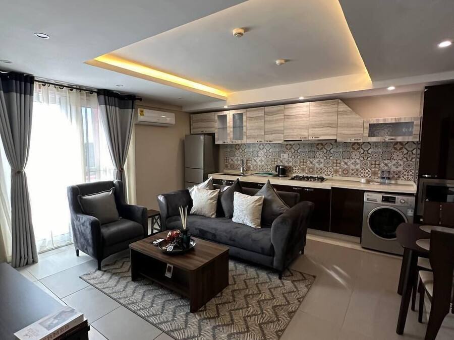 Deluxe Apartment, 1 Bedroom, Beach View, Poolside | Living area | 50-inch Smart TV with digital channels, pay movies