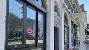 A building with large windows and a sign that reads "ginger coffee." - HARVEST MOON - ROMANTIC - OFF GRID - WINE TRAIL CABIN - Pet Friendly! 4 Seasons (Prattsburgh)