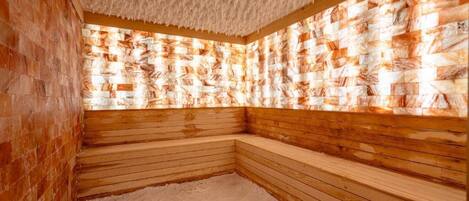 A sauna room with wooden benches and a textured ceiling.