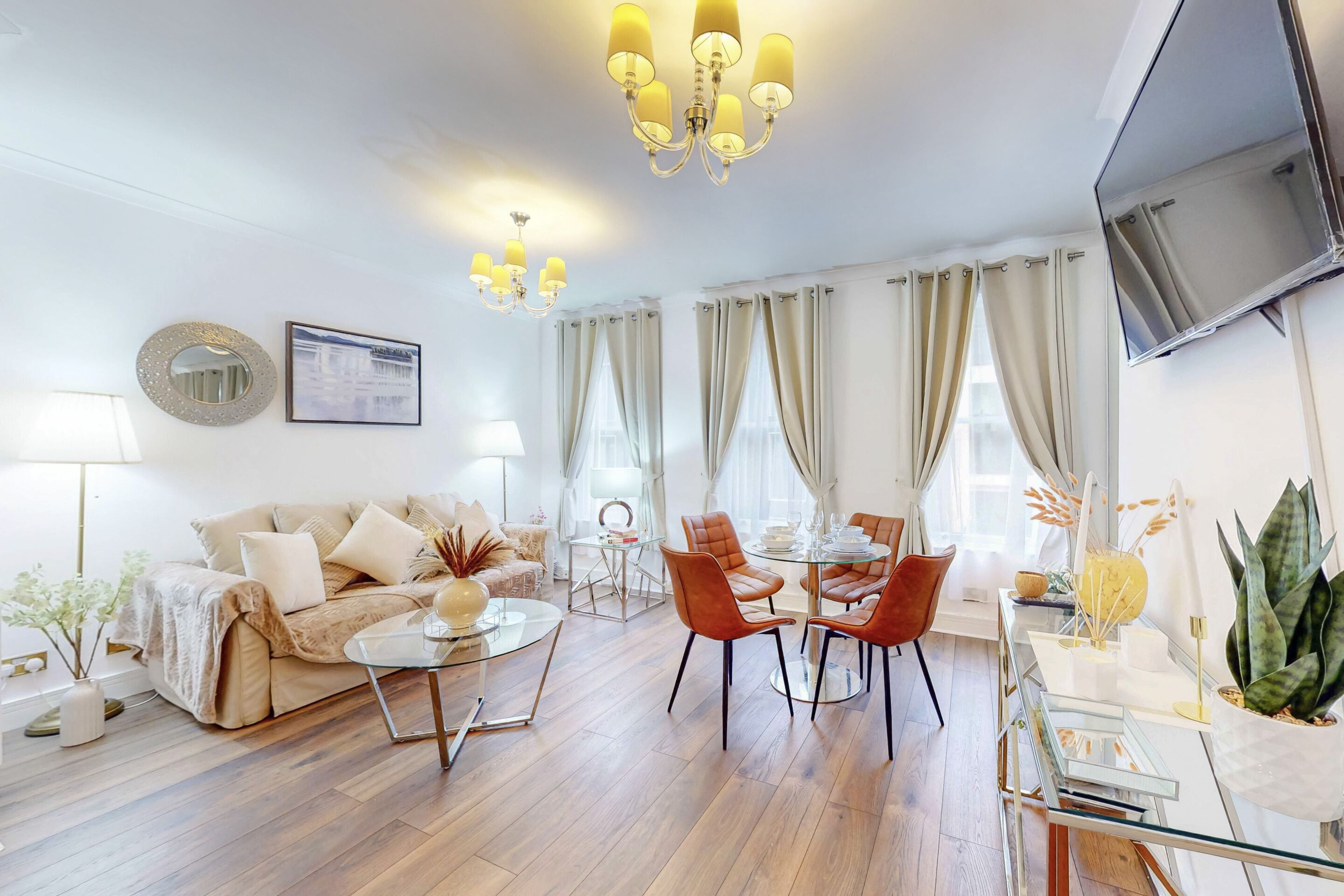 A modern living room with a sofa, coffee table, and dining area.