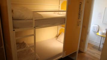 A bunk bed room with a door labeled "Safestay hostels".