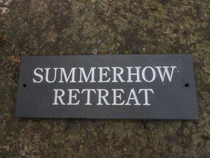 A sign that reads "SUMMERHOW RETREAT" on a dark, textured surface. - Summerhow Retreat (Kendal)