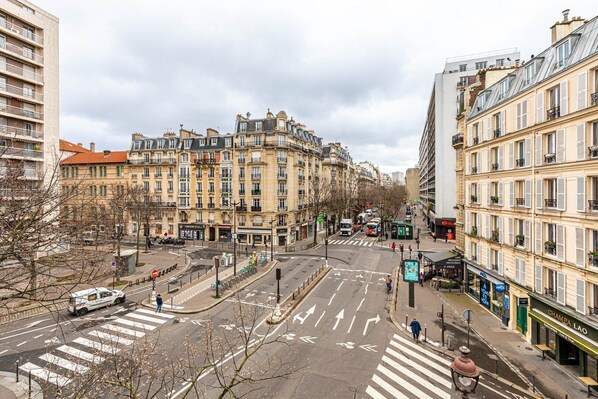A street view with buildings, a crosswalk, and a pedestrian.