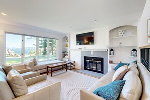 TV, books - Tranquil lakeside retreat with beach access, pool, firepit, & lovely patio views (Gilford)