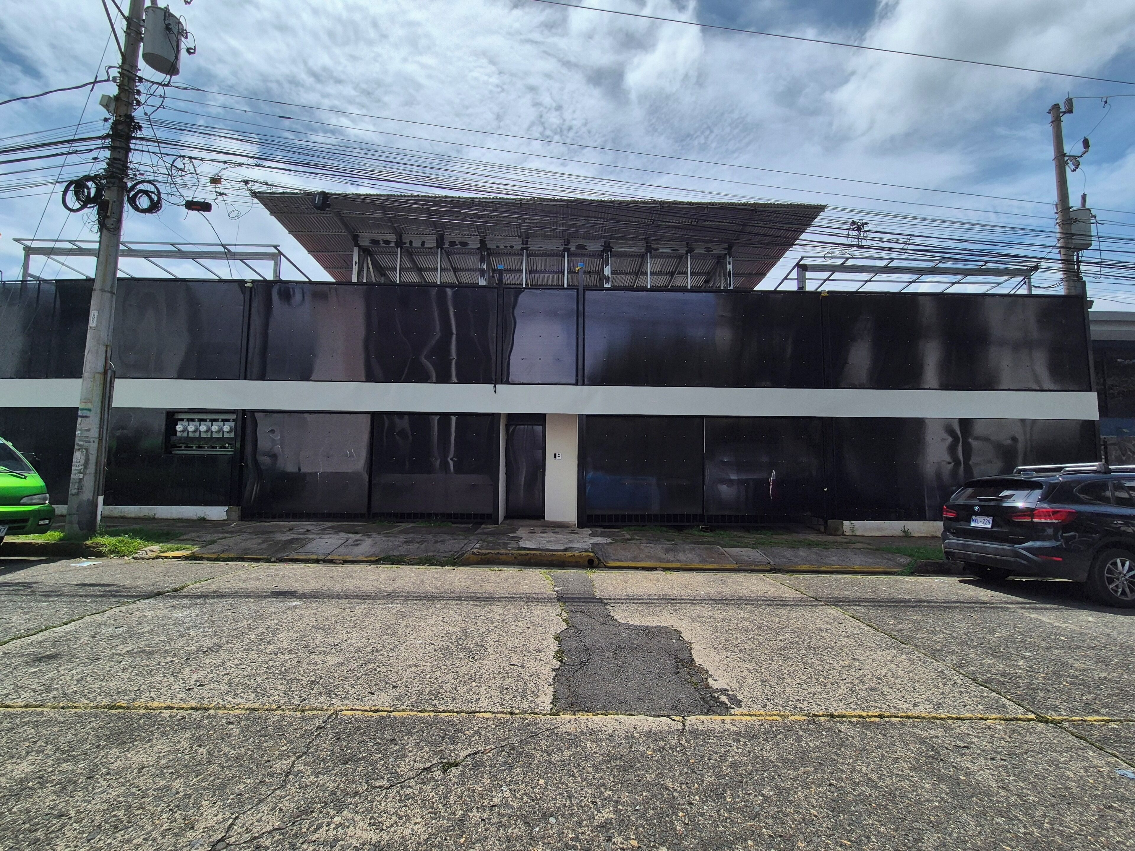 A modern building with a flat roof and large glass windows.