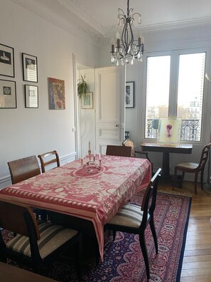 Enjoy meals in this elegant dining room with a large table, six comfortable chairs, and a beautiful city view.