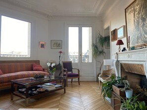 Relax in this stylish living room with a city view, comfortable sofa, and cozy fireplace.