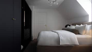 A bedroom with a large bed, a wardrobe, and a skylight.