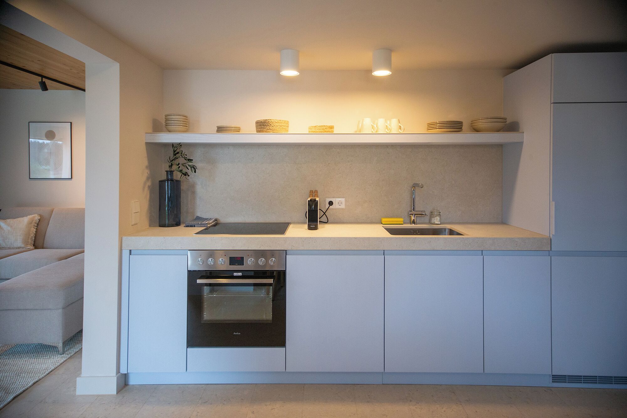 A compact kitchen with a built-in oven, a sink, and a countertop.
