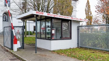 A small, white building with a sign reading "209 Bürgermeister-Simdt-Straße".