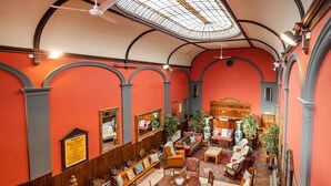 A spacious room with a high ceiling, wooden furniture, and a large window. - The Old Sunday School & Vestry (Cromer)