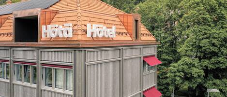 A hotel with a red-tiled roof and a sign that reads "Hotel Hotel."