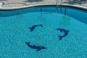 A swimming pool with dolphin mosaic tiles. - Emerald Dolphin Unit 650 (Pensacola Beach)
