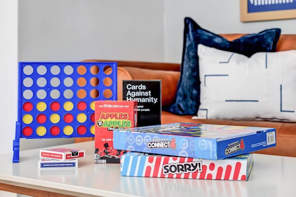 A table with various board games and a Connect4 game box.