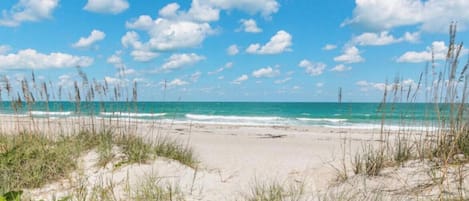 A beach with clear skies and ocean waves.