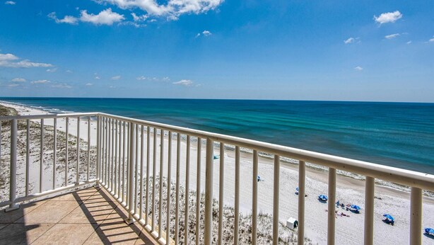 A balcony with a view of a beach and ocean. - Sans Souci Unit 704 (Pensacola Beach)