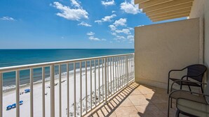 A balcony with a view of a beach and ocean. - Sans Souci Unit 704 (Pensacola Beach)