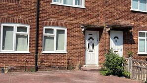 A two-story brick house with a front entrance, two windows on the ground floor, and a tiled roof. - Flat 1,1 bedroom flat sleeps 4 in Abingdon Oxfordshire (Abingdon)