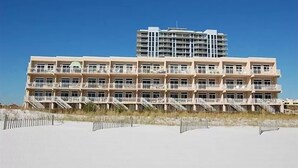 A multi-story hotel with balconies, located near a beach. - Seahorse Unit R (Pensacola Beach)