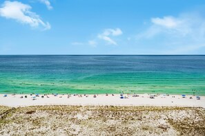 A beach with clear turquoise water and a sandy shore.
