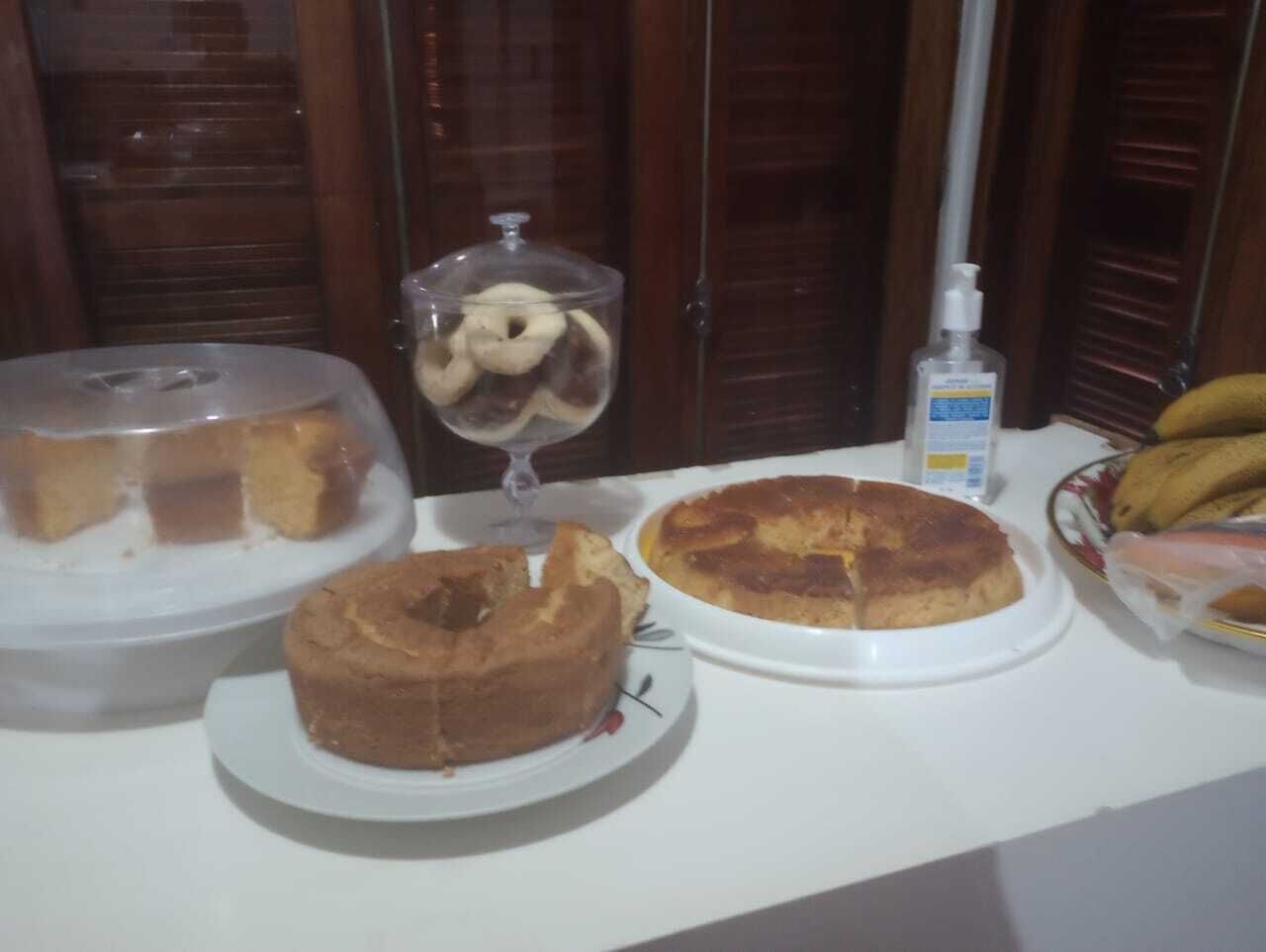 A table with various desserts including a cake, a pie, and a glass of dessert.