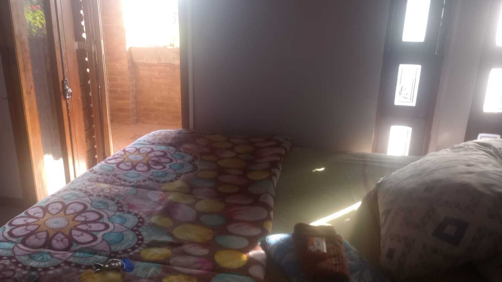 A room with a bed, a window, and a door.