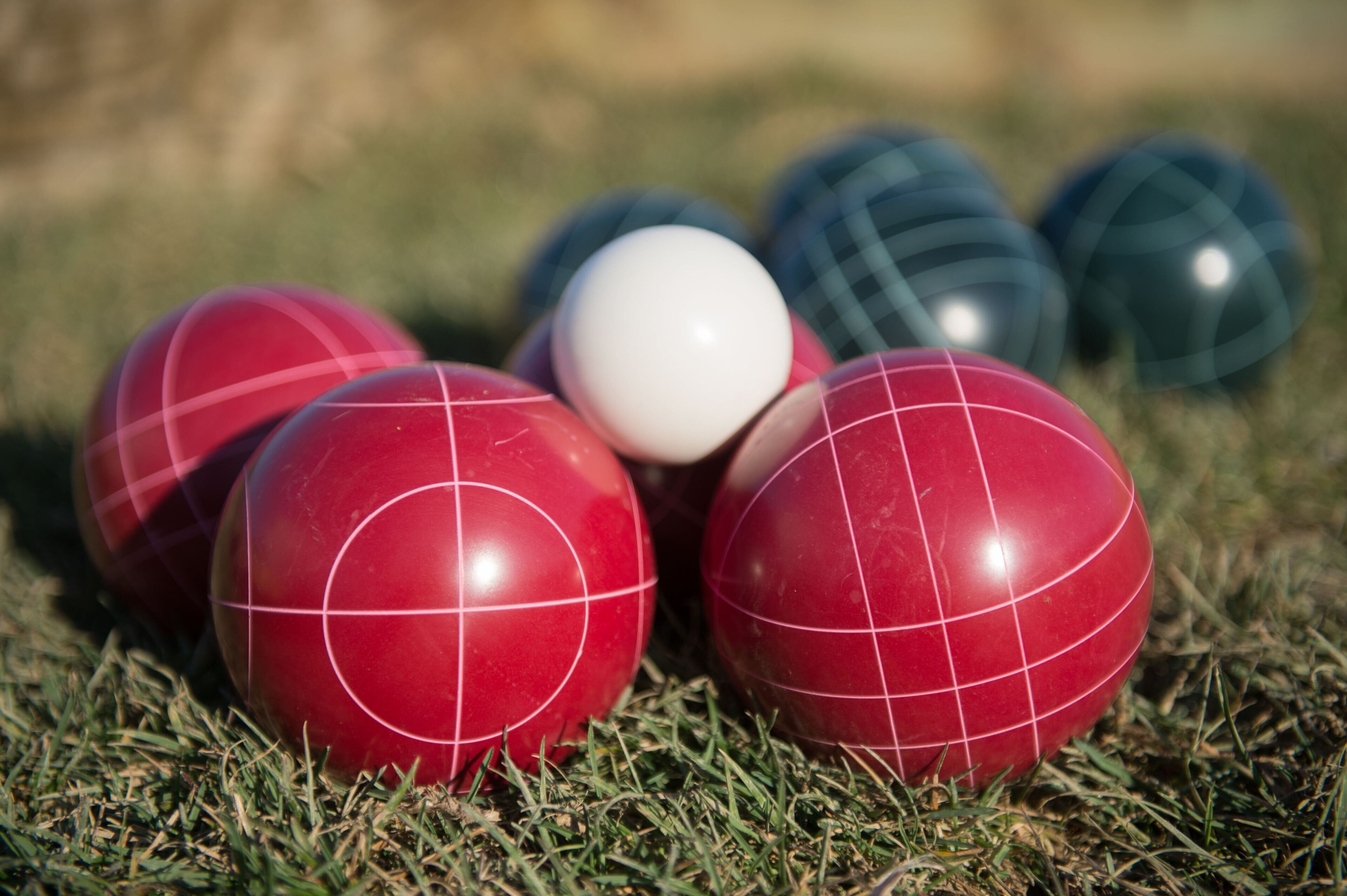 A group of croquet balls on grass.