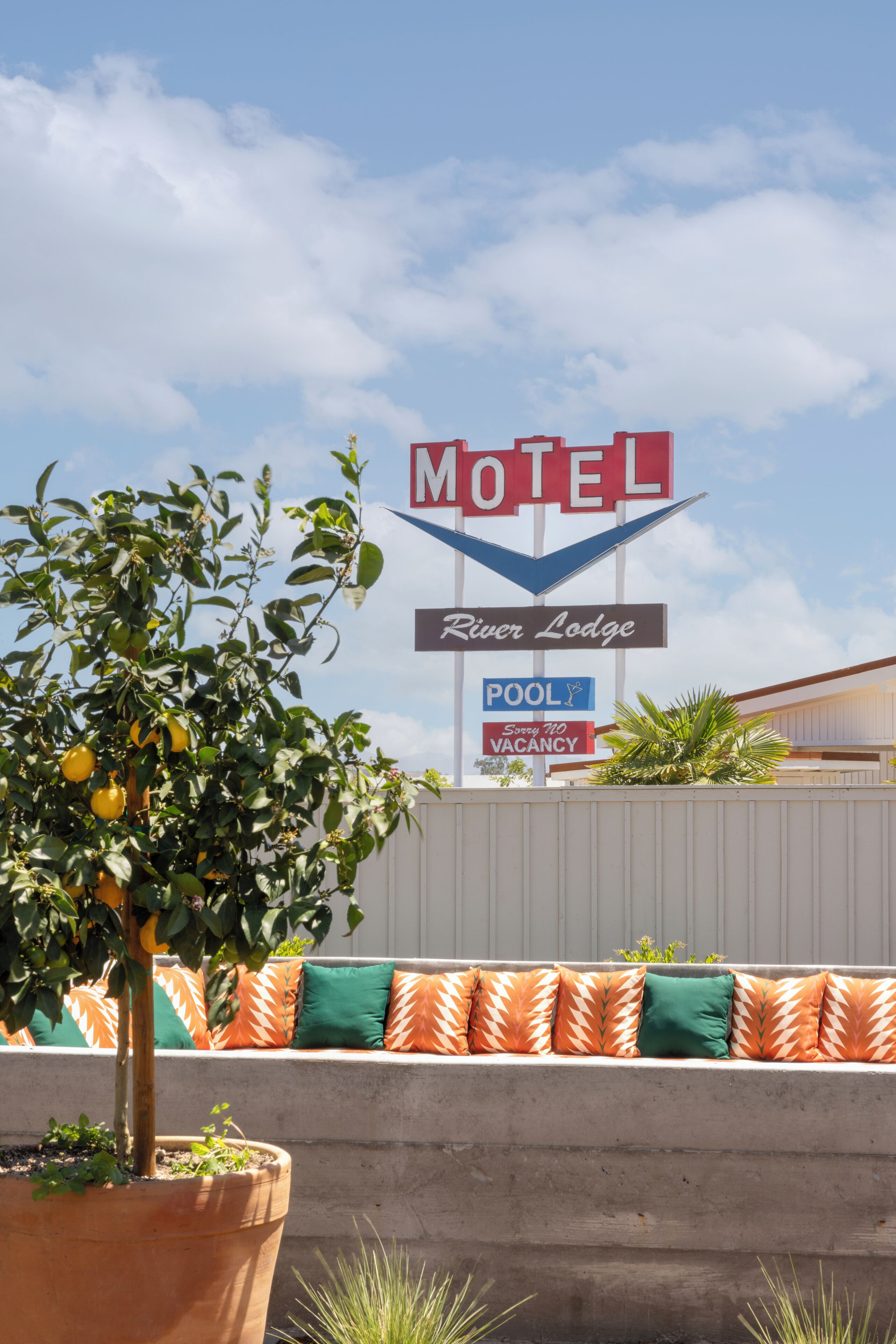 A motel sign with a pool and vacancy notice.