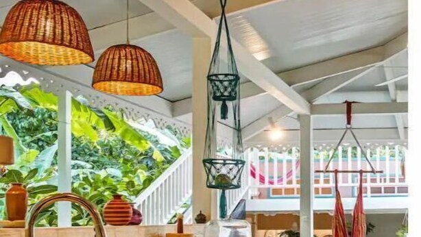 A kitchen with wooden countertops, a sink, and hanging pendant lights. - Flower of Life (Limon Province)