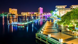 A waterfront promenade with a dock, a boat, and a building labeled "Tampa Convention Center". - Bposhtels Clearwater Tampa (Clearwater)