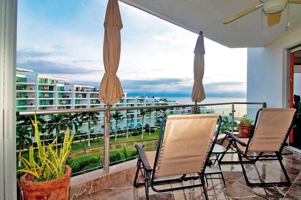 Private terrace attached to master bedroom with sun umbrellas and lounge chairs