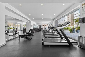 A modern gym with treadmills, weight machines, and free weights. - 2BR Residence • Private Pool • Canal • Beach (Las Jarretaderas)
