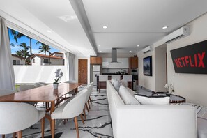 A modern interior with a dining area, kitchen, and living space.