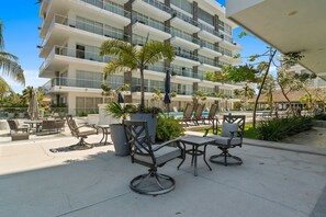 A modern hotel with a pool area, outdoor seating, and a view of the building. - 2BR Residence • Private Pool • Canal • Beach (Las Jarretaderas)