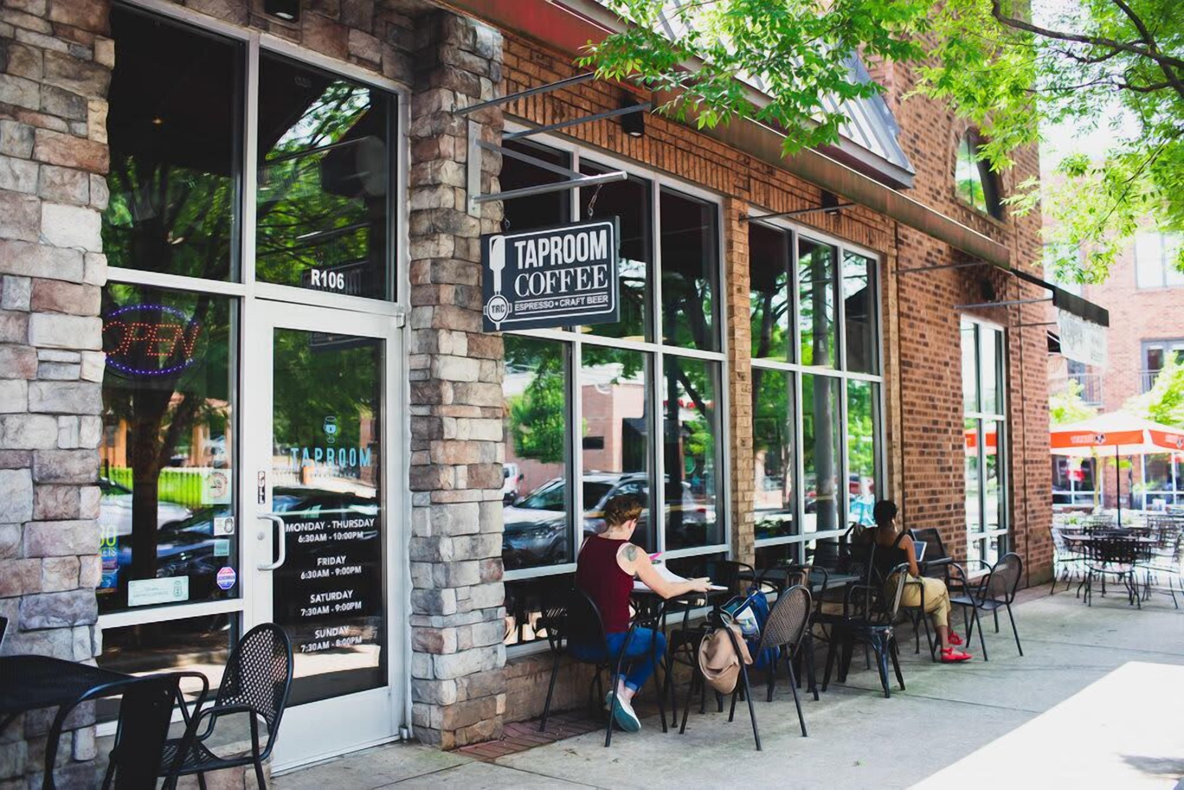 A coffee shop with outdoor seating, a sign indicating it serves espresso and craft beer, and a visible address number R106.