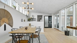 A modern kitchen with a large island, stainless steel appliances, and a view through the glass door. - Cozy home in Aakirkeby with WiFi (Aakirkeby)