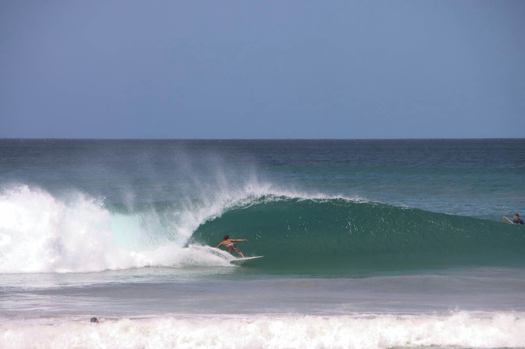 A surfer riding a wave in the ocean.