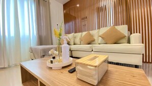 A modern living room with a wooden coffee table, a sofa with cushions, and a decorative vase. - Rustic charm meets modern elegance at our wood & white retreat. (Butuan City)