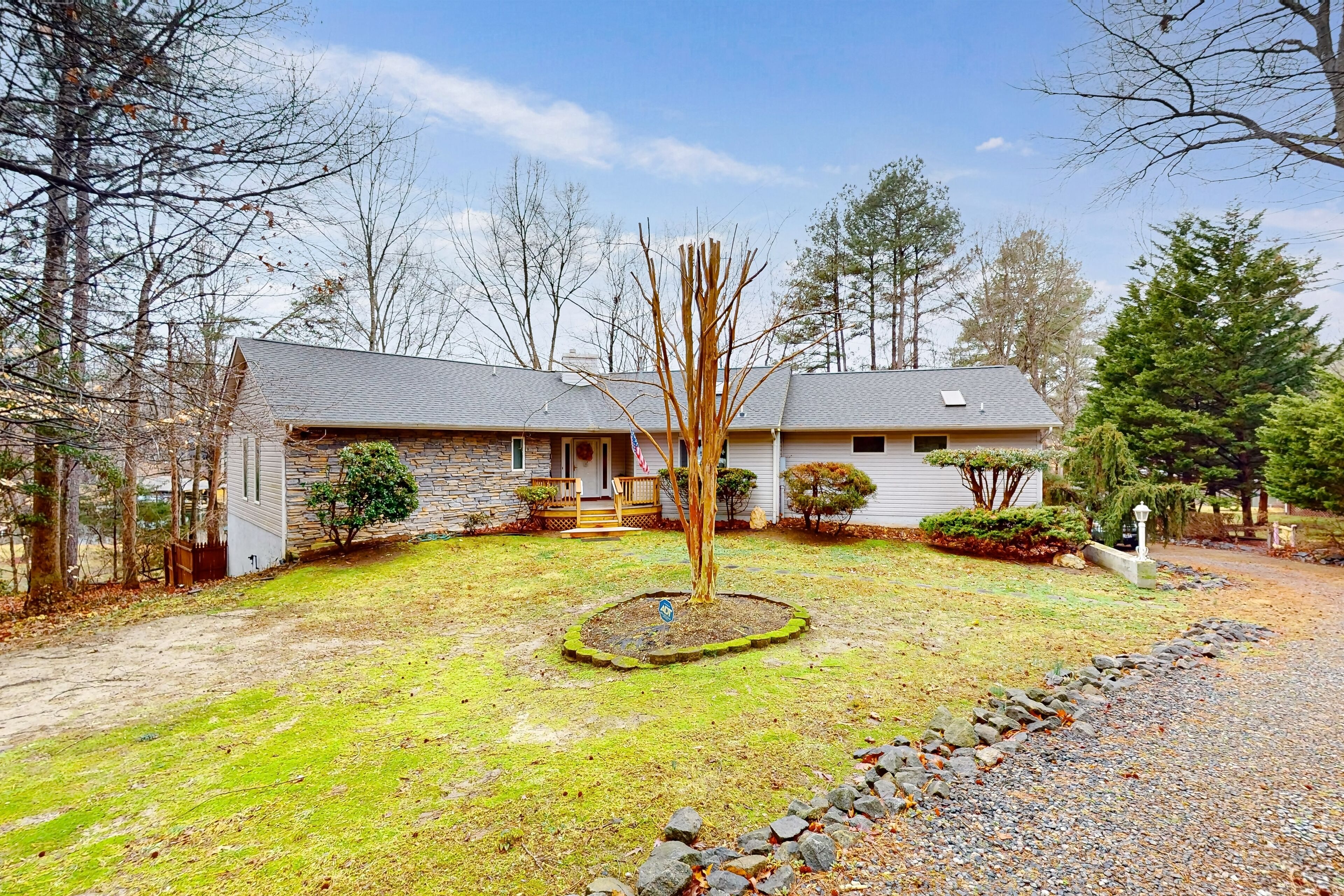 Beautiful lakefront home with over 150 ft. of shore, sandy beach, & boat dock
