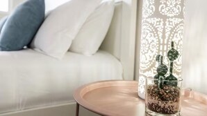 A living room with a white sofa, a glass table with a cactus, and a decorative lamp. - ☆Mediterranean Retreat☆King Bed★Fireplace★Garage (Edmonton)