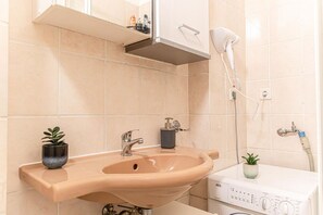 Shower, hair dryer, towels, soap
