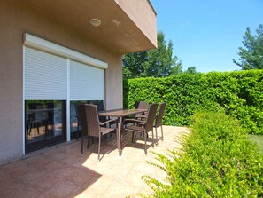 Enjoy dining or socializing in this patio area with a table and chairs.