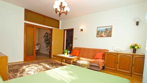 A cozy room with a bed, a sofa, a table, and a cabinet. - Holiday apartment with air conditioning (Valbandon)