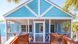 A blue building with a porch and a number '5' on the door. - Swim Spa, Tiki Bar, Pet friendly, Fenced yard, 3 min walk to beach - The Blue House (Isle Of Palms)