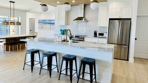 A modern kitchen with a large island, stainless steel appliances, and a wooden ceiling. - Punta Gorda Canal Waterfront I Pool, Kayaks, Bikes, Boat Dock (Punta Gorda)