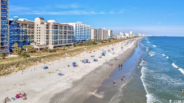 A beachside hotel with multiple floors, a sandy beach, and ocean views. - Two of the three bedrooms have ocean front balconies! (North Myrtle Beach)