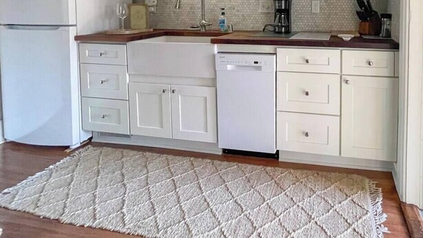 A kitchen with white cabinets, a microwave, a dishwasher, and a sink. - Historic Downtown Luxury-Lake-Coffee-Spa like BA (Delafield)